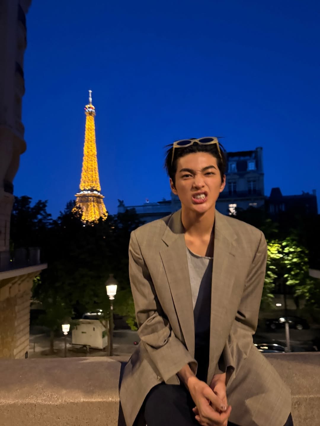 Making playful faces in front of Eiffel Tower